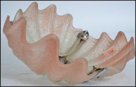 A 1930's Art Deco clam shell Odeon style ceiling light having white frosted glass clam shell