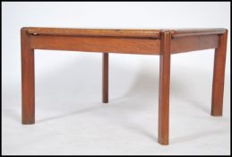 A 1970's Tarn Stole Danish teak wood coffee table of square form being raised on chamfered edge