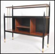 A 1950's believed G-Plan teak wood and ebonised Librenza type pattern bookcase having open window