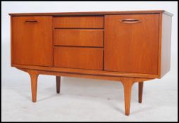 A retro 1960's / 1970's teak wood sideboard of smaller proportions having a central bank of three
