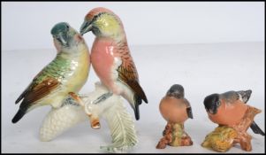 A German Karl Ens ceramic bird figurine group of Crossbills set on a naturalistic base with makers