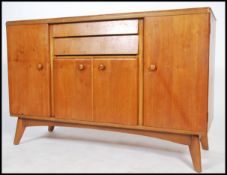 A 1950's retro walnut sideboard dresser being of shaped form having cupbards and drawers with a