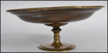 A vintage 20th century copper and brass tazza having a waisted base with central medallion cast in