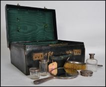 A gentlemans / ladies vanity case with silver hallmarked contents to include  bottles, pots,