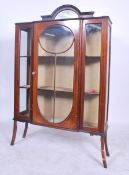An Edwardian mahogany inlaid upright display cabinet being raised on squared legs with twin door
