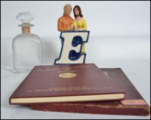 A retro 20th century point of sale breweriana ceramic advertising piece of a young couple at a bar