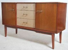 A retro 1960's Danish influence sideboard in teak being raised on tapered legs with two tone