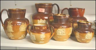 A good group of early 20th century Royal Doulton harvest wear jugs of graduating size along with a