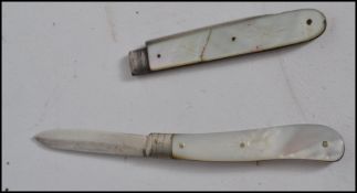 Two silver hallmarked mother of pearl handled fruit knives one being hallmarked for Sheffield 1922