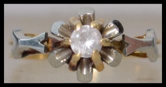An 18ct gold and white single stone ladies ring. The round cut stone approx 10pnts being claw