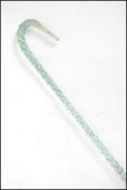 A large 19th century Nailsea glass type walking stick of large spiral twist tapering form with crook