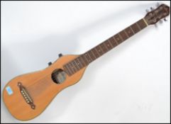 A contemporary electric Ashbury acoustic guitar model STR-100 having a mandolin shaped body with a