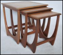 A 1970's G-Plan Kelso teak and tile top nest of tables. The tables of graduating form with tiled