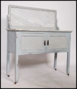 An Edwardian painted shabby chic marble top washstand being raised on squared legs with twin
