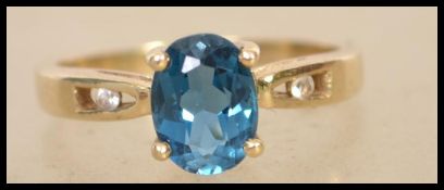 A hallmarked 9ct gold ring set with an oval cut bl