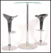A 20th century glass topped bistro style table, glass top raised on a chromed pedestal base with a