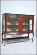 An Edwardian mahogany chiffonier display cabinet raised on shaped legs with glass display cabinet
