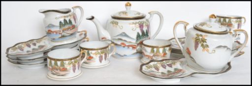 An Oriental Kutani 6 person tea service consisting of cups with tennis saucers, teapot, creamer,