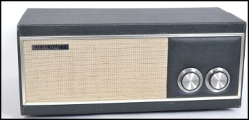 A vintage 1950's two tone portable record player by Marconiphone having dial facia with hinged