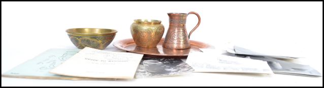 A group of Islamic copper and brass wares to include a small jug, bowl, a plate depicting a harem of
