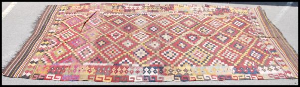 A large and colourful Afghan handwoven  Maimana Kilim rug having multiple diamond lozenge centre