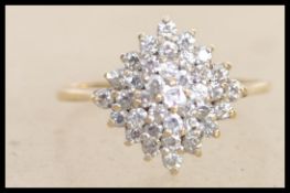 A hallmarked 9ct gold cluster ring set with white stones. Hallmarked Birmingham. Size Q.5. Weight2.