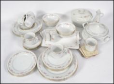 A large chintzy pattern Bone China extensive floral tea and dinner service consisting of trio's