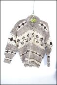 A vintage 1960s Native Canadian / American woollen cardigan in a white buffalo style having a zip to