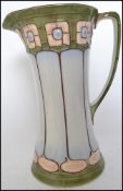 A Victorian Art Nouveau jug of tapering form decor
