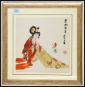 A 20th century framed and glazed Chinese needlepoint silk picture depicting a seated girl. Chinese