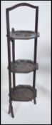 A Victorian carved oak 3 tier metamorphic cake stand having handle over folding octagonal trays each