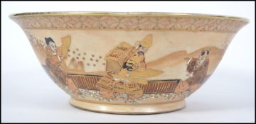 A believed 19th century Japanese Satsuma bowl having geometric patterns to the borders with warriors