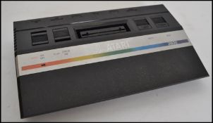 A vintage Atari 2600 games console complete with many games to include Centipede, Mrs Pacman, Pole