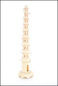 An early 20th century Japanese ivory pagoda tower ornament with bell adornments to the tapering