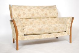 A contemporary Ercol two seater sofa / settee having a chintzy fabric upholstery  ( Fabric No E015 )