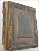 A good 19th century Victorian leather tooled photograph album to include portrait studies in black