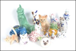 A collection of ceramic cats to include a Devon Studio Zalmen cart, A Sylvac cat group inside a boot
