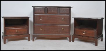 A pair of Stag mahogany ' minstrel ' bedside cabinets, each with single drawers and open shelves
