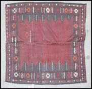 An Afghan / Persian Balouch Kilim rug having dark red  central ground with central spiral medallions