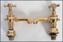 A pair of vintage 20th century Victorian style brass bathroom taps by Adams and Sons.