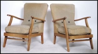 A pair of 1950's retro armchairs. Original upholstered seat and back cushions, shaped beech wood