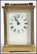 An 20TH century brass cased  column carriage clock having five bevel edged glass panels, enamel dial
