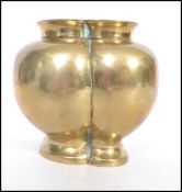 A believed 19th century or earlier Chinese brass low vase of lobed form with cast marking to the