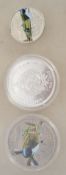 A group of three silver white metal coins to include