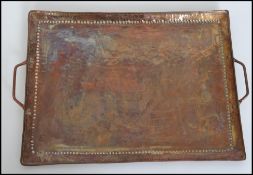A Newlwyn school Arts and Crafts hammered copper tray by John Pearson, of twin handled rectangular