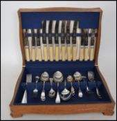 A good 20th century Bilchrome oak cased canteen of cutlery having a blue velvet fitted interior