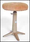 A retro vintage industrial machinist stool, having a circular pad, raised on tubular frame with an
