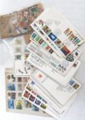 A collection of First Day covers and 1st day Issues together with loose stamps from around the world
