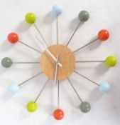 A retro Sputnik / atomic clock with central dial having sunburst tubular metal rays with ball finial