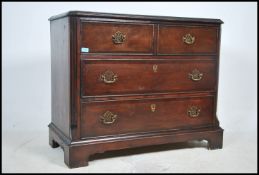 A Georgian style mahogany chest of drawers being raised on bracket feet having 2 short over 2 deep